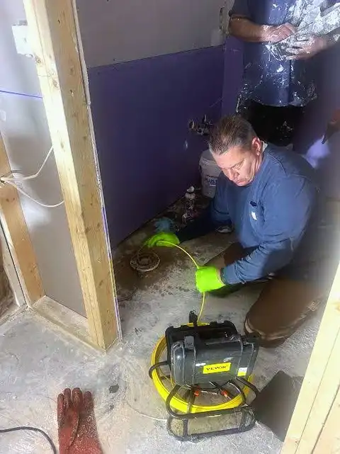 Joe Messina running a sewer camera to locate an underground problem