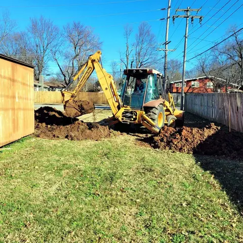Messina backhoe trenching a water line