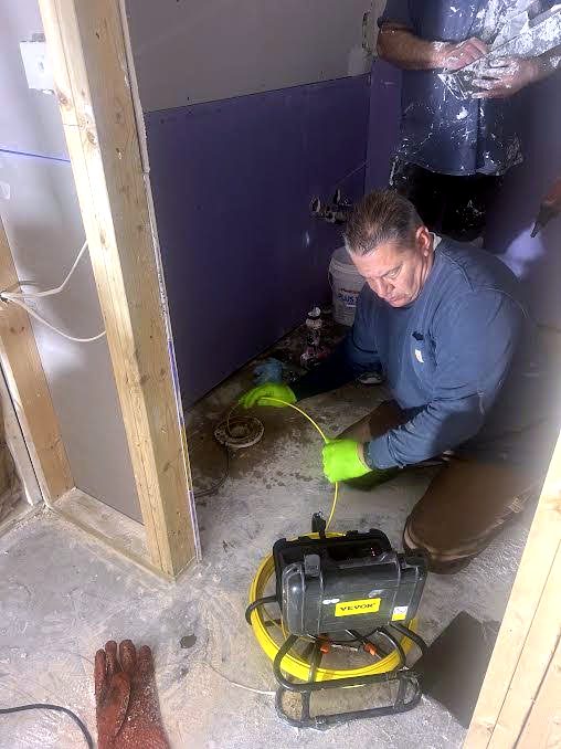 Joe Messina running a sewer camera to locate an underground problem